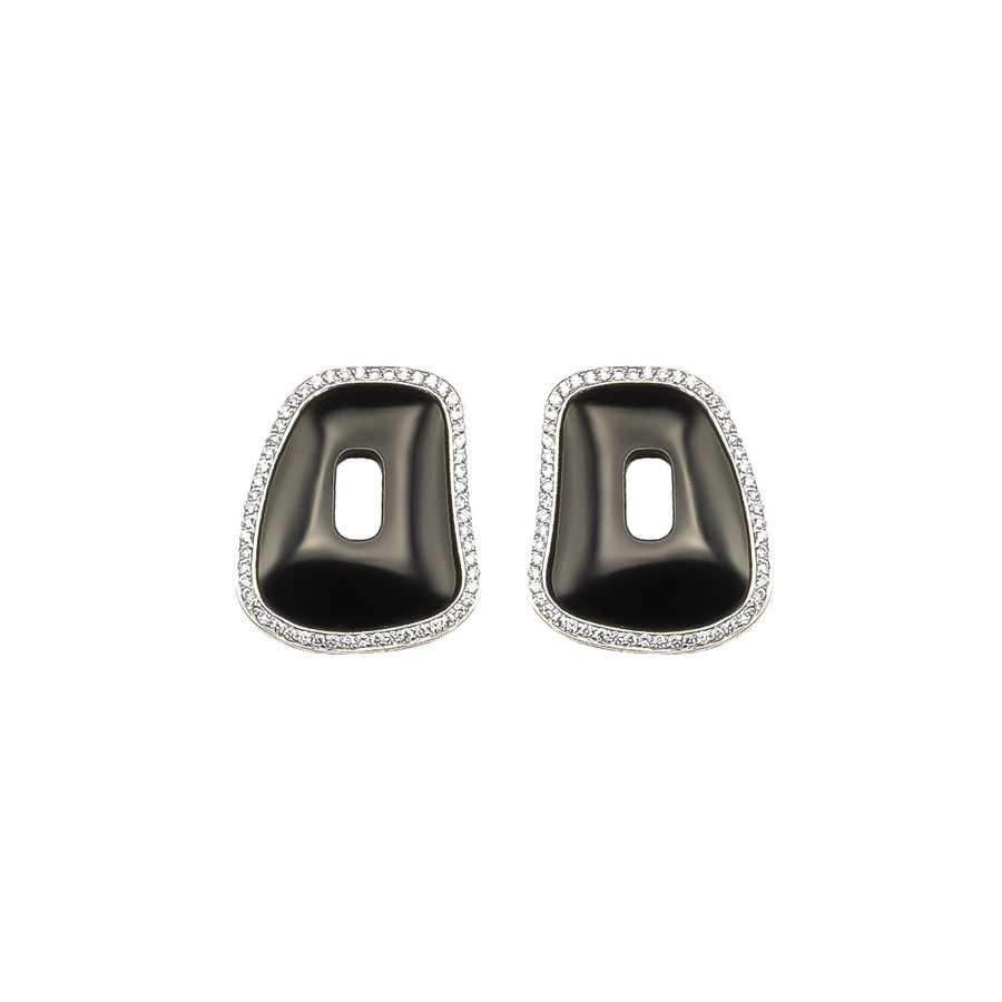 One pair of Puzzle element framed in 18k white gold and white diamonds with black onyx