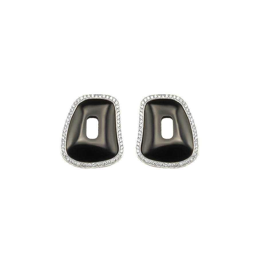 One pair of Puzzle element framed in 18k white gold and white diamonds with black onyx